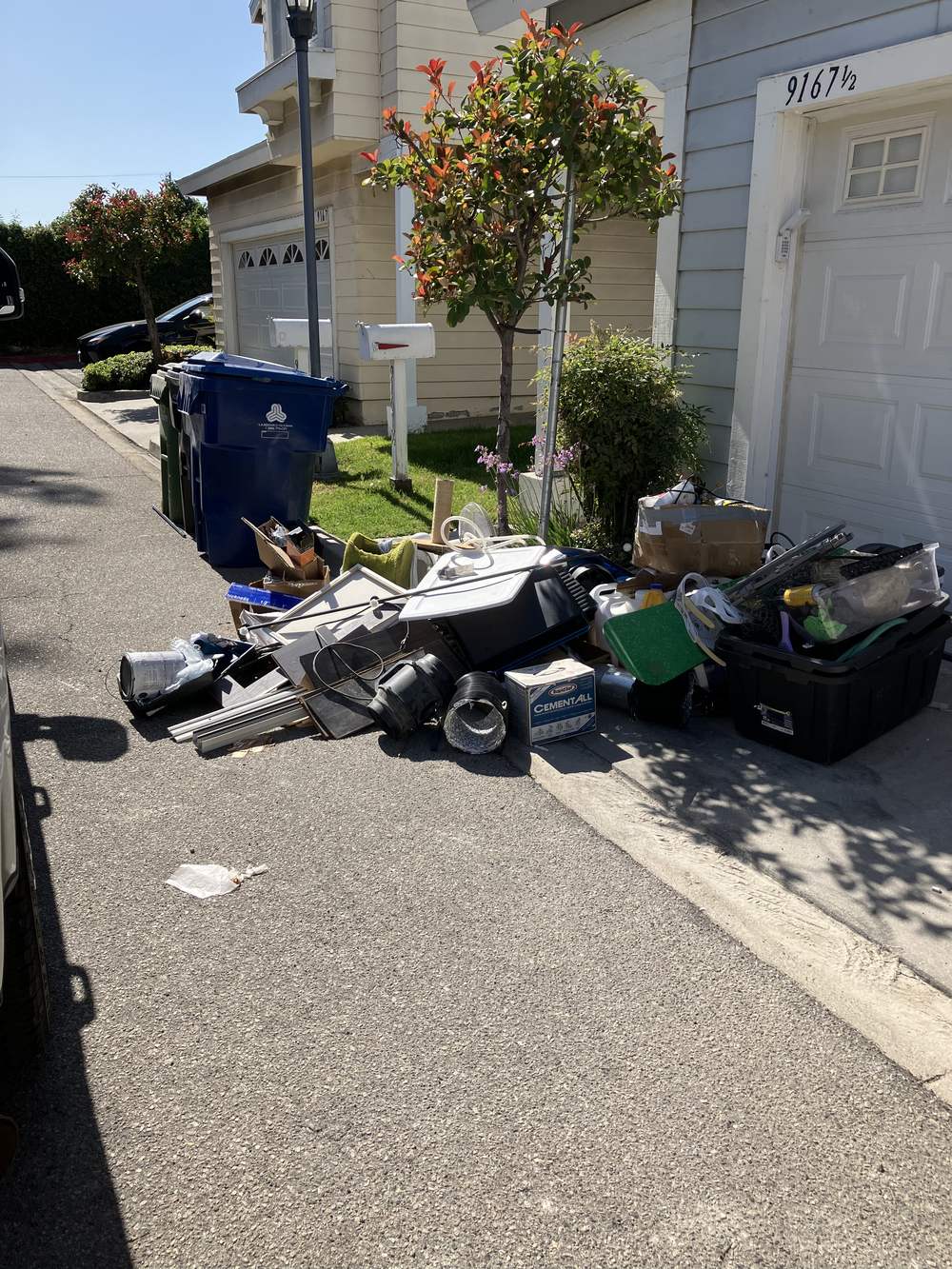 Household items staged for pickup outside a San Fernando home