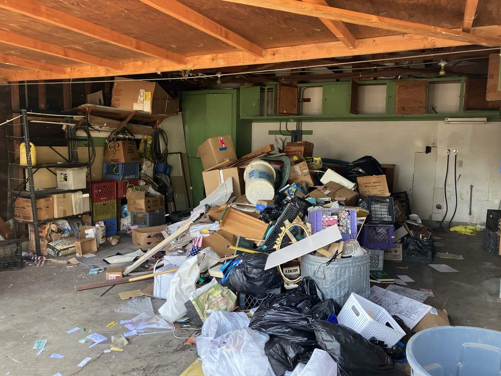 A packed garage before a hoarding cleanup in San Fernando